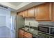 The kitchen includes stainless steel appliances, a double sink, and dark granite countertops at 1402 E Guadalupe Rd # 122, Tempe, AZ 85283