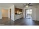 Open-concept living room boasts sliding glass doors to the balcony and breakfast bar to the kitchen at 1402 E Guadalupe Rd # 122, Tempe, AZ 85283