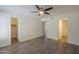Cozy main bedroom features wood-look floors, multiple doors, and a ceiling fan at 1402 E Guadalupe Rd # 122, Tempe, AZ 85283