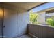 This quiet patio space with a wooden railing offers serene views of nearby trees and neighboring buildings at 1402 E Guadalupe Rd # 122, Tempe, AZ 85283