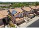 Aerial shot showcasing a home with solar panels, desert landscaping, and a tile roof at 14186 N 100Th Pl, Scottsdale, AZ 85260