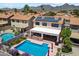 Aerial view of a home with a pool and solar panels, nestled within a vibrant community at 14186 N 100Th Pl, Scottsdale, AZ 85260