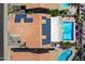 Drone image shows solar panels installed, covered patio, and the nearby pool in the backyard at 14186 N 100Th Pl, Scottsdale, AZ 85260