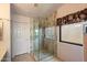 Shower featuring glass doors and tile surround at 14186 N 100Th Pl, Scottsdale, AZ 85260