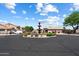 A well-maintained community roundabout with mature landscaping, fountain, and manicured lawns at 14186 N 100Th Pl, Scottsdale, AZ 85260