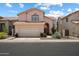 Charming two-story home with a tile roof, desert landscaping, and a two-car garage at 14186 N 100Th Pl, Scottsdale, AZ 85260