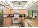 Well-lit kitchen features granite countertops, oak cabinets, and modern appliances at 14186 N 100Th Pl, Scottsdale, AZ 85260