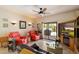 Cozy living room with comfortable seating, a ceiling fan, and a sliding glass door to the patio at 14186 N 100Th Pl, Scottsdale, AZ 85260