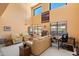 Bright living room featuring soaring ceilings, ample natural light, and a cozy seating area at 14186 N 100Th Pl, Scottsdale, AZ 85260
