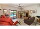 Relaxing living room with patio access, a ceiling fan, and views of the pool and lush backyard at 14186 N 100Th Pl, Scottsdale, AZ 85260