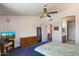 Bright main bedroom featuring neutral colors, a ceiling fan and tv at 14186 N 100Th Pl, Scottsdale, AZ 85260