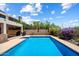 Sparkling pool with mature landscaping, umbrella, and a patio area ideal for outdoor entertaining at 14186 N 100Th Pl, Scottsdale, AZ 85260