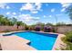 Inviting in-ground pool surrounded by lush landscaping and a privacy wall offers a serene outdoor retreat at 14186 N 100Th Pl, Scottsdale, AZ 85260