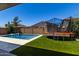 Inviting backyard featuring a pool, trampoline, lush turf, and ample space for recreation at 20926 E Longwood Dr, Queen Creek, AZ 85142