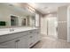Bright bathroom featuring double vanity sinks and a glass-enclosed shower at 20926 E Longwood Dr, Queen Creek, AZ 85142