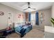 This bedroom features a ceiling fan, window, bed, carpeted floor, mirror, and decorative wall art at 20926 E Longwood Dr, Queen Creek, AZ 85142