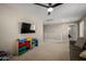 Spacious bonus room with a large TV and neutral carpet, perfect for entertainment and relaxation at 20926 E Longwood Dr, Queen Creek, AZ 85142