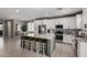 Spacious kitchen features an island with seating, stainless appliances, and white cabinets at 20926 E Longwood Dr, Queen Creek, AZ 85142