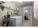 Well-equipped laundry room with modern washer and dryer, ample shelving, and neutral wall color at 20926 E Longwood Dr, Queen Creek, AZ 85142