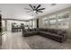 Bright, open floor plan features an island, a spacious sectional sofa, and tile flooring at 20926 E Longwood Dr, Queen Creek, AZ 85142