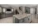 Open-concept living room with an island, fireplace, and a staircase at 20926 E Longwood Dr, Queen Creek, AZ 85142