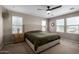 Serene main bedroom with neutral tones, king-size bed, and abundant natural light from multiple windows at 20926 E Longwood Dr, Queen Creek, AZ 85142