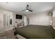 The comfortable main bedroom has a TV, built-in storage and neutral decor at 20926 E Longwood Dr, Queen Creek, AZ 85142