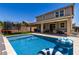 Backyard pool with turf, trampoline, and patio, ideal for outdoor enjoyment and relaxation at 20926 E Longwood Dr, Queen Creek, AZ 85142