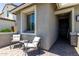 Inviting front porch area with comfortable seating and a stylish entryway at 20926 E Longwood Dr, Queen Creek, AZ 85142