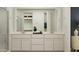 Bright bathroom featuring double sinks and a large mirror over white vanity at 23345 W Mobile Ln, Buckeye, AZ 85326