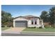 Charming single-story home featuring a tile roof, two-car garage, and manicured landscaping at 23345 W Mobile Ln, Buckeye, AZ 85326