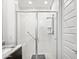 Well-lit bathroom featuring a tiled shower with glass doors and chrome fixtures at 24776 N 171St Ln, Surprise, AZ 85387