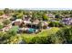 Sprawling backyard with a pool, tennis court, and mature landscaping from an aerial view at 2558 E Page Ct, Gilbert, AZ 85234