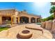 Backyard patio with fire pit, outdoor kitchen, and pool with rock features, ideal for entertaining at 2558 E Page Ct, Gilbert, AZ 85234