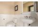 Classic bathroom features a pedestal sink, white wainscoting, and neutral tones at 2558 E Page Ct, Gilbert, AZ 85234