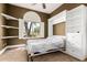 Comfortable bedroom featuring built-in shelves, a murphy bed, and a bright window at 2558 E Page Ct, Gilbert, AZ 85234