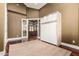 Neutral bedroom with a Murphy bed and a view into another room with wood floors at 2558 E Page Ct, Gilbert, AZ 85234
