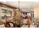 Elegant dining room with beautiful lighting, a glass table, and views of the outdoor kitchen at 2558 E Page Ct, Gilbert, AZ 85234