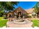 Stunning stone home with a circular driveway and a beautiful water fountain feature at 2558 E Page Ct, Gilbert, AZ 85234