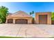 Spacious four-car garage with neutral colors and tile roof, ideal for car enthusiasts or extra storage at 2558 E Page Ct, Gilbert, AZ 85234