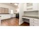 Well-lit laundry room with a built-in desk, cabinets, and a modern washer and dryer at 2558 E Page Ct, Gilbert, AZ 85234