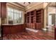 Traditional home office with wooden built-ins and a large window for natural light at 2558 E Page Ct, Gilbert, AZ 85234