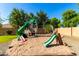 Backyard playground with slides, swings, and a sandbox, perfect for Gathering fun at 2558 E Page Ct, Gilbert, AZ 85234