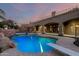 Beautiful pool featuring a rock waterfall and diving board, with an entertainment area nearby at 2558 E Page Ct, Gilbert, AZ 85234