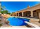Beautiful backyard pool featuring a diving board, waterfall and mature landscaping at 2558 E Page Ct, Gilbert, AZ 85234