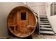 Backyard barrel sauna featuring wooden construction, built-in seating, and easy access to stairs at 2558 E Page Ct, Gilbert, AZ 85234