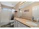 A bathroom features double sinks, a wide mirror, and a shower-tub combo at 25818 N 68Th Ave, Peoria, AZ 85383