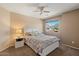 This bedroom has a ceiling fan, natural light, and neutral wall-to-wall carpeting at 25818 N 68Th Ave, Peoria, AZ 85383