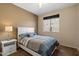 Bedroom featuring a queen-sized bed, side table and natural light from the window at 25818 N 68Th Ave, Peoria, AZ 85383