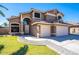 Beautiful two-story home with a well-manicured front yard and a three-car garage at 25818 N 68Th Ave, Peoria, AZ 85383
